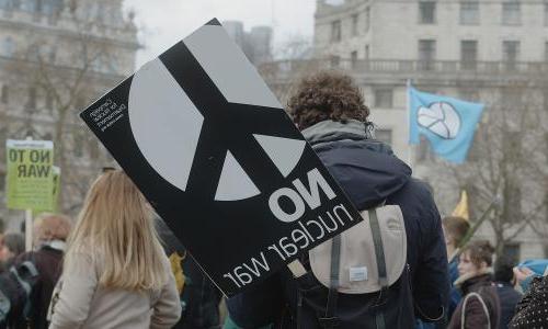  A man at a rally on London's Trafalgar Square with a sign, ‘No Nuclear War’, campaigning for nuclear disarmament, in support for the Ukrainian people at war.